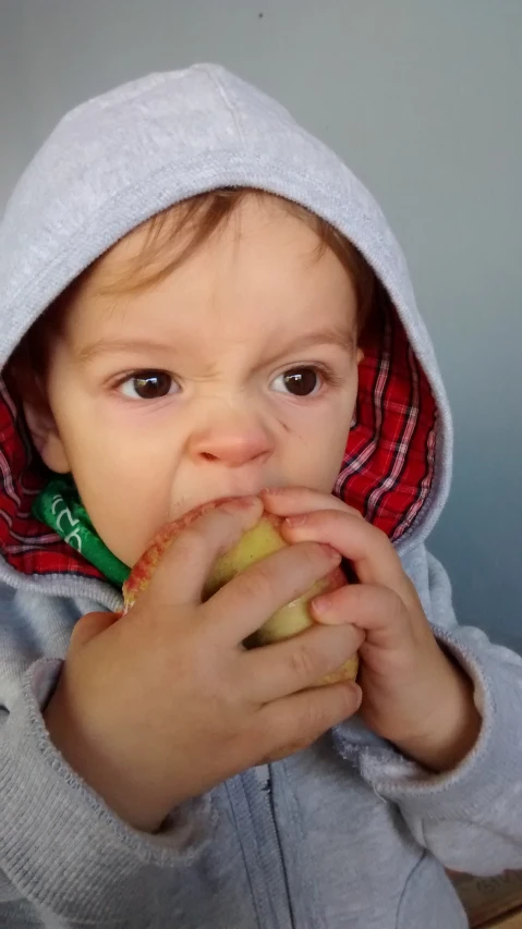 a close up of a child with food in his mouth