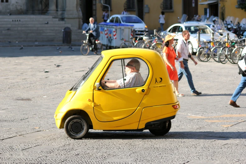 a small car with a man in the driver seat