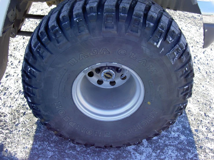 a big tire on the side of a large trailer