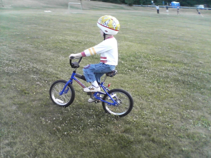 a  riding a bike in a field