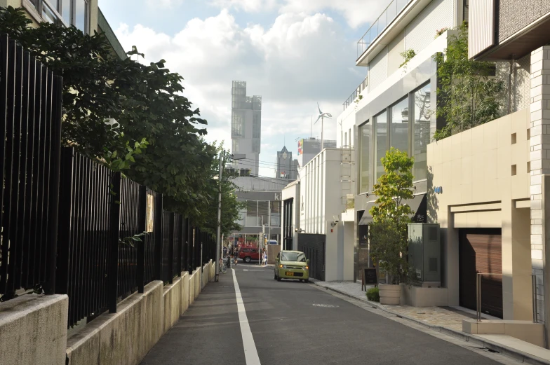 a deserted street lined with apartment buildings and trees