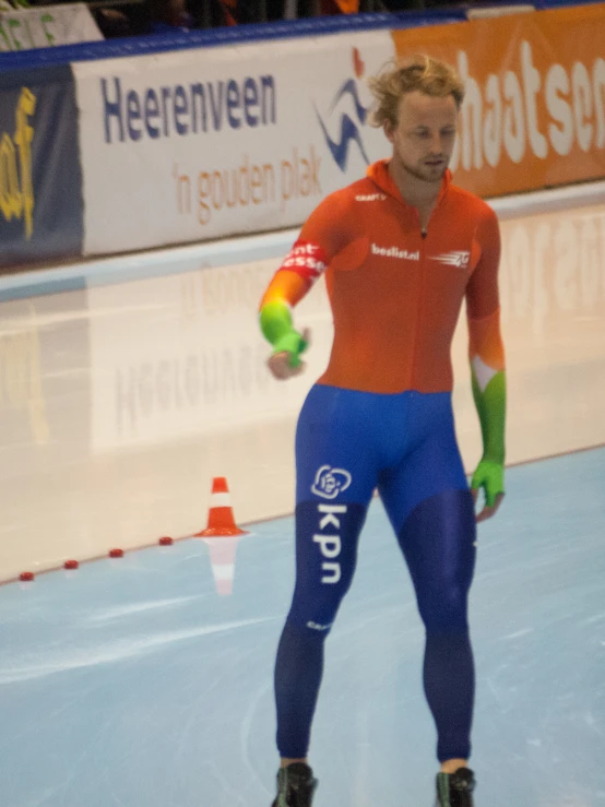 man on a skateboard at an indoor rink playing with a ball