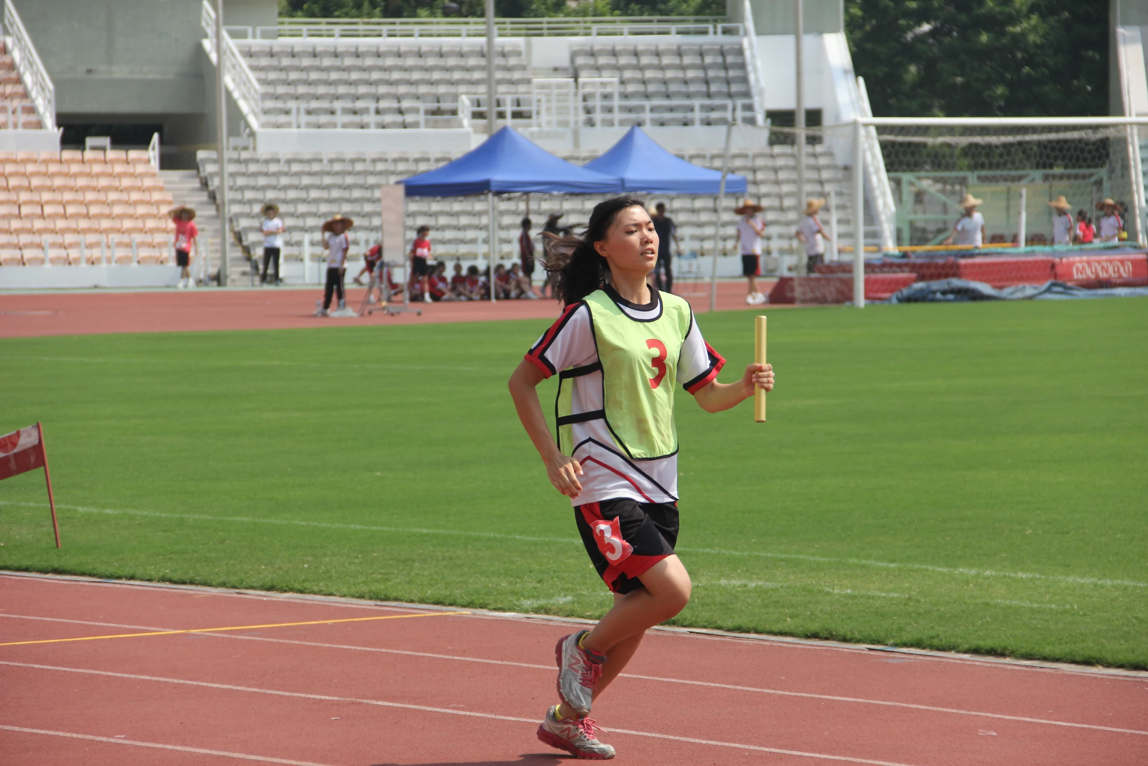 the young woman is running down the running track