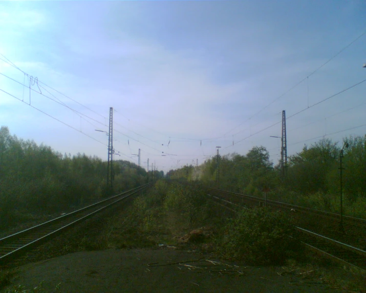 several train tracks in a field that looks old