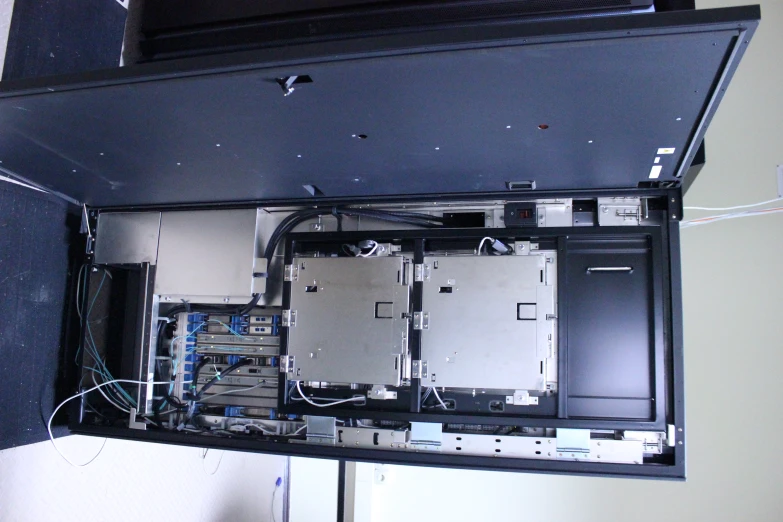 the view from under the enclosure door shows all of the electronic components and wires connected to the motherboard