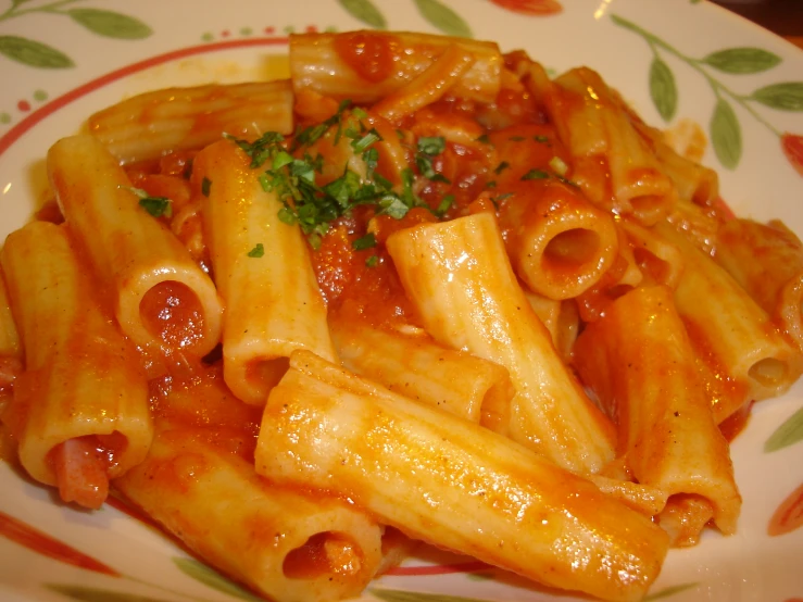 pasta is being served with tomato sauce and parsley