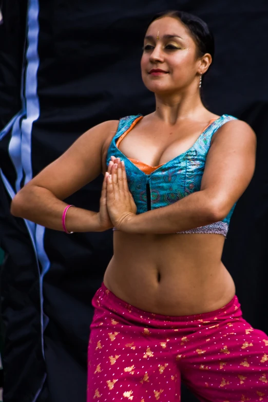 a woman with an intense look while holding her hands in pray