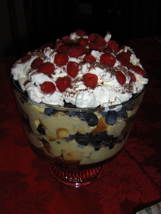 a fancy trifle covered with berries and cream