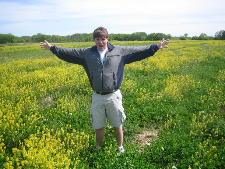 a man with his hands out in a field