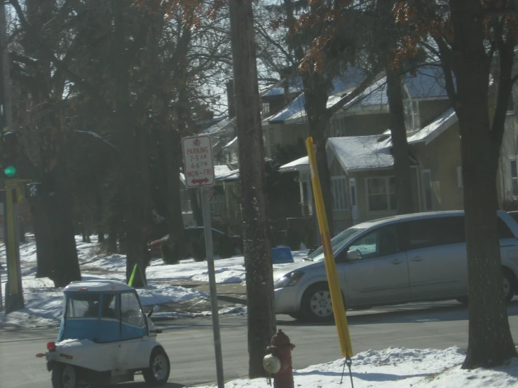 a car is parked next to a street with lots of snow