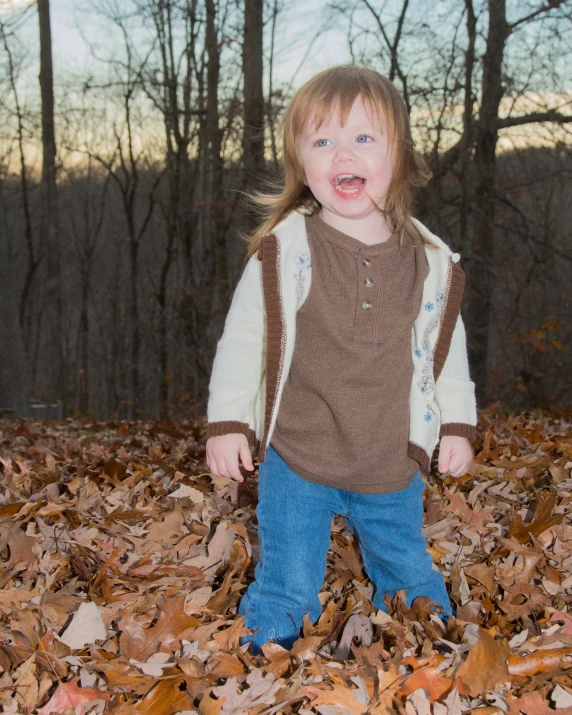 the child in the leaves is crying for what they are looking