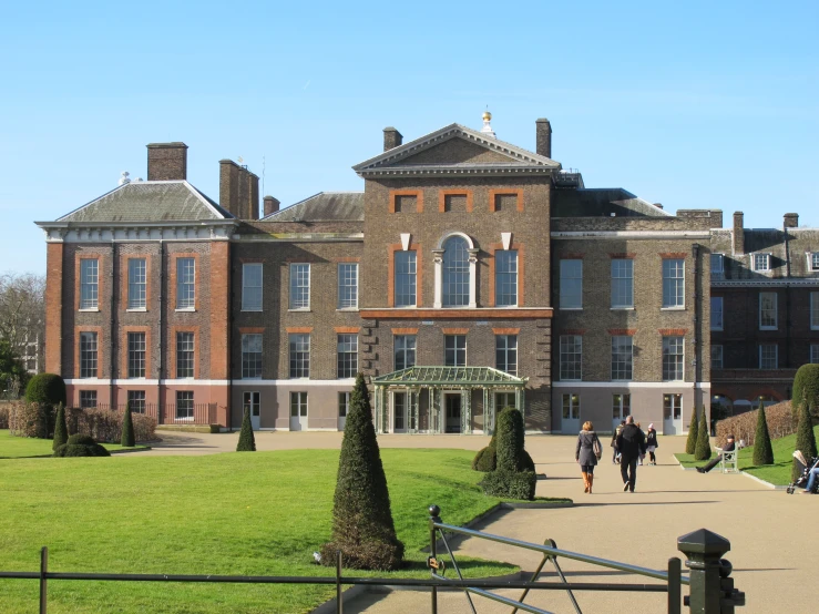 a large red brick building surrounded by trees