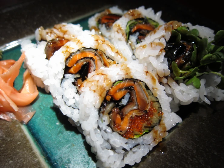 some vegetables are placed on some rice next to a cut up carrot