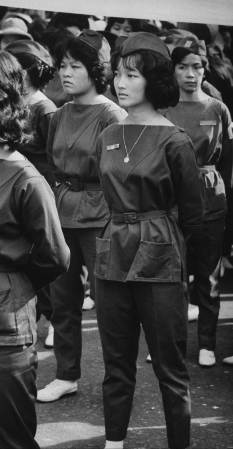 several women are walking through an open area