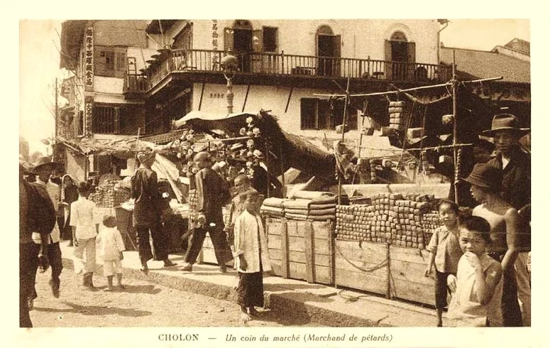 a crowd of people gathered near the ocean near some buildings