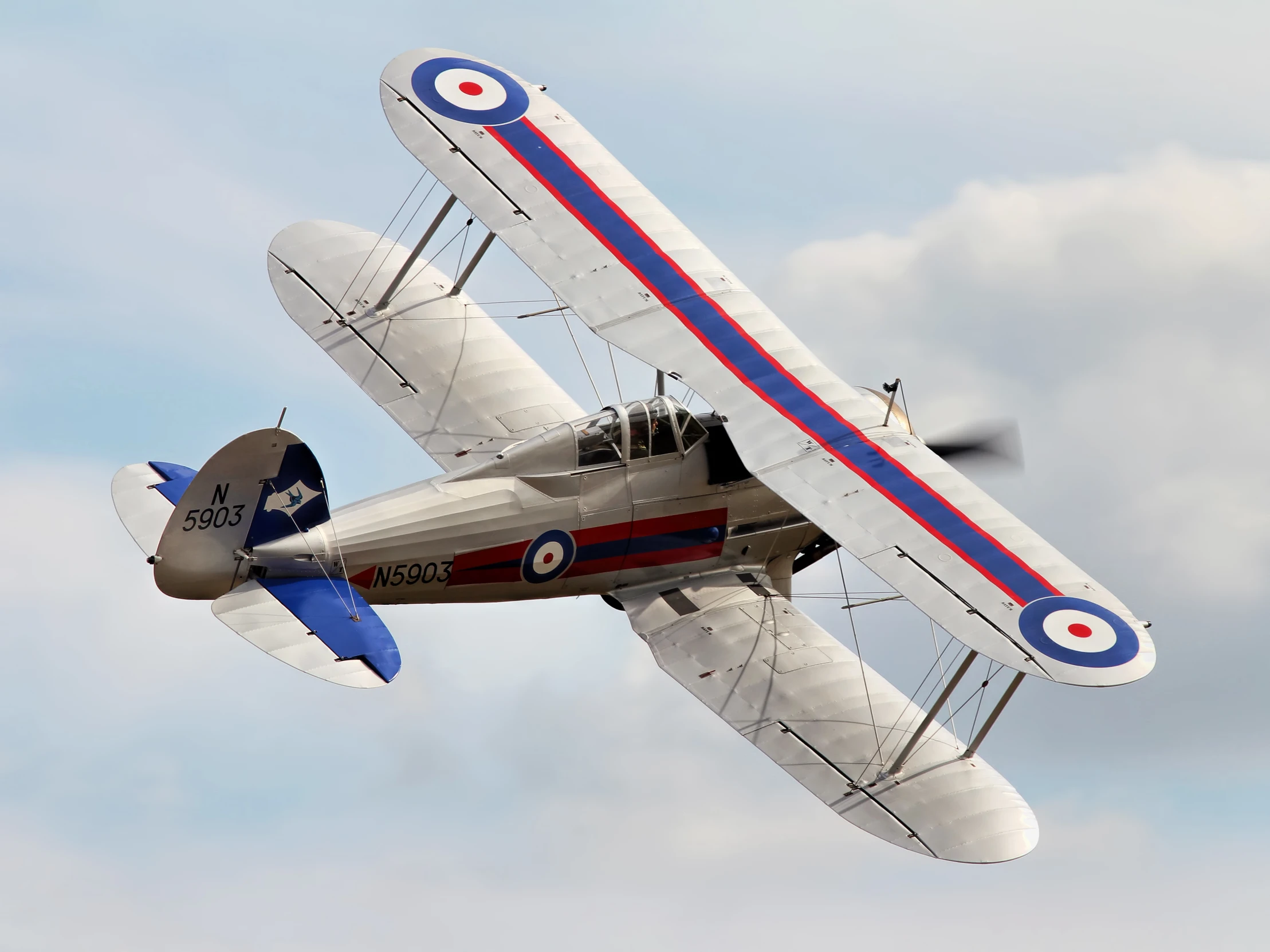 a single engine propeller plane flying in the sky