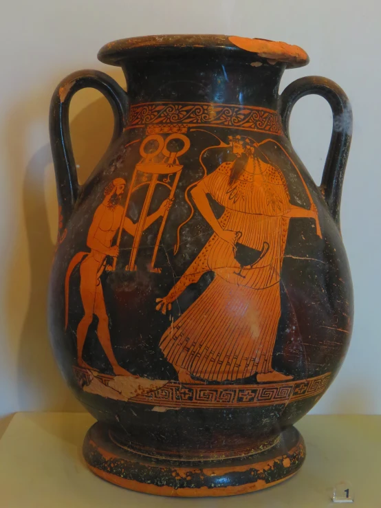 an ancient vase sitting on a table with an advertise of a man and woman