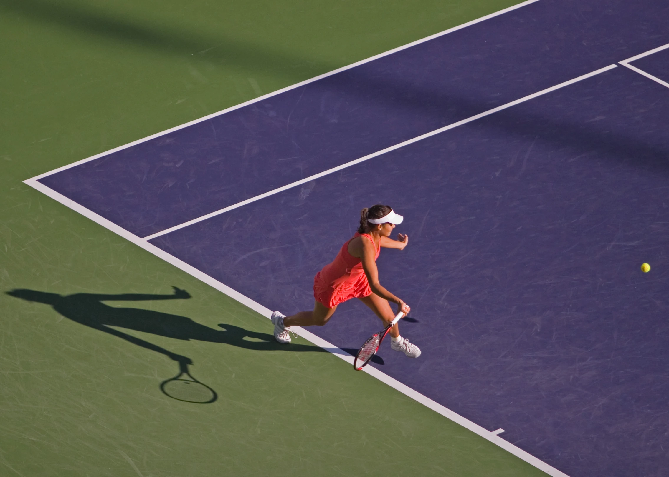 a woman swinging her tennis racquet at a ball