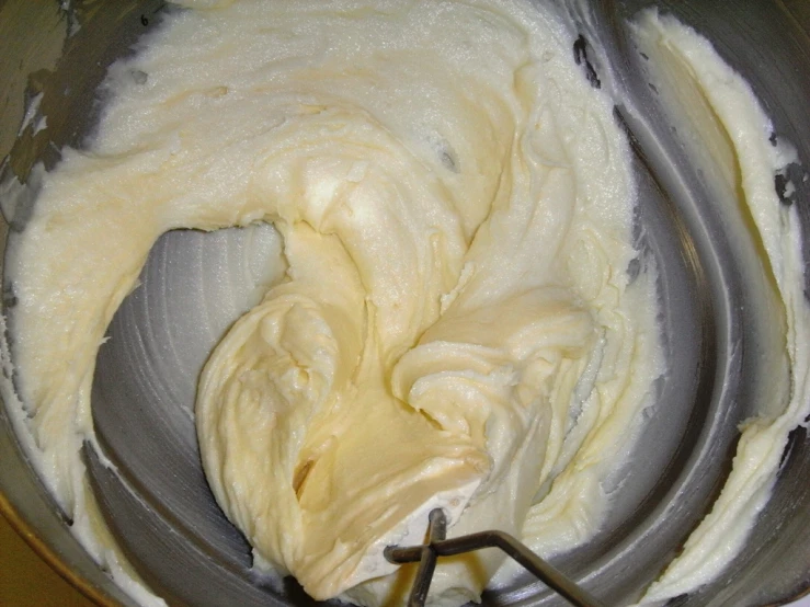 a mixing bowl full of white cream in a blender