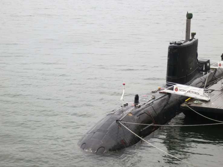 a submarine that is in the water and tied to a boat