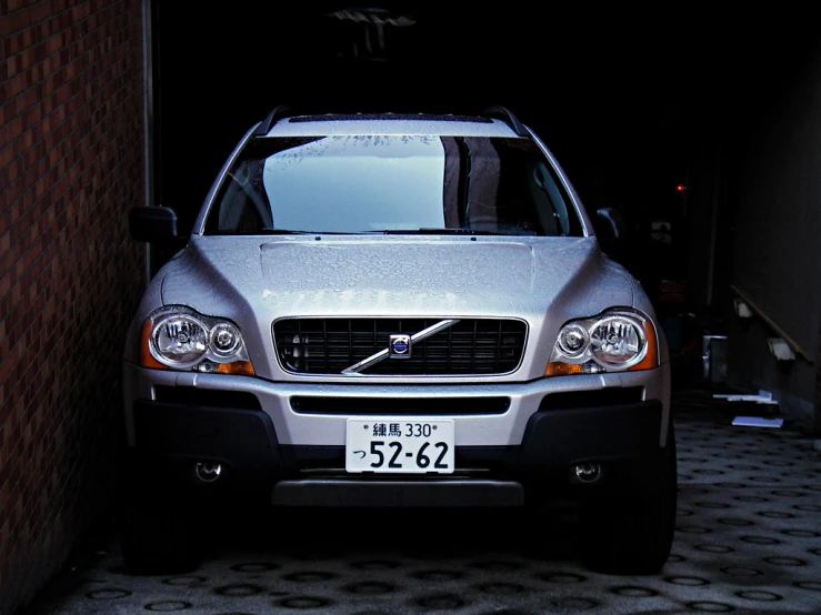 a silver car parked in a dark alley