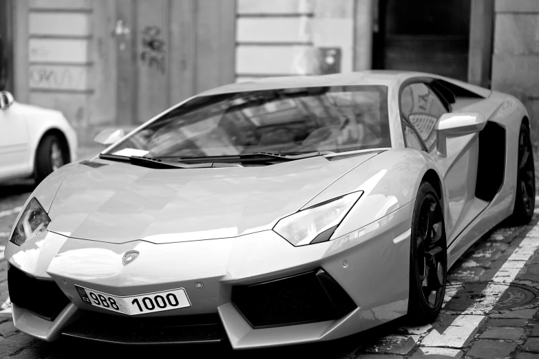 two sports cars parked on the side of a road