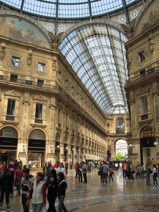 a large group of people that are walking down a hall