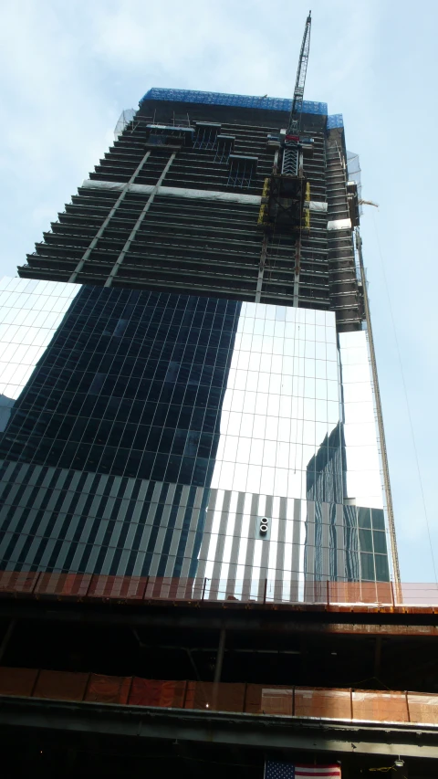 a high rise building and a person working with scaffolding