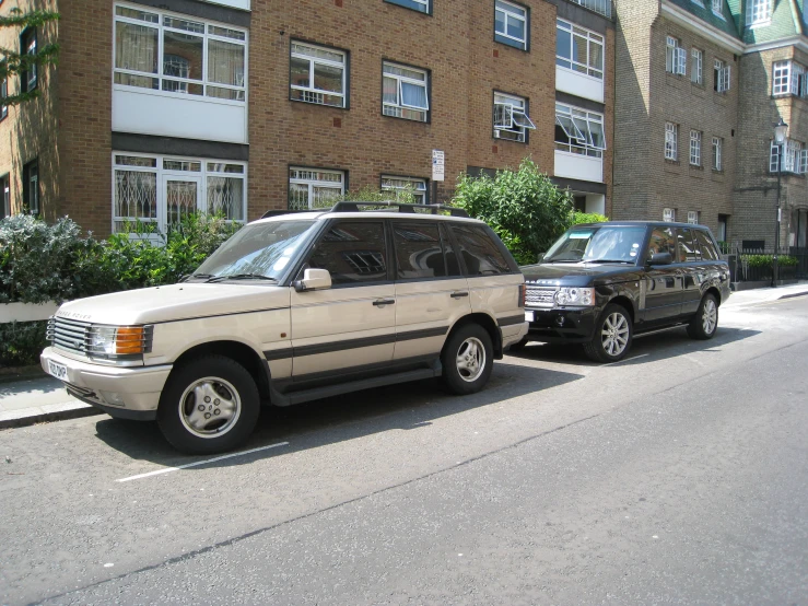 two parked cars and some bushes and trees