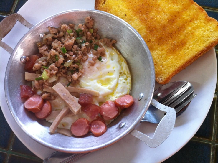 a dish with meats and bread sitting on a plate