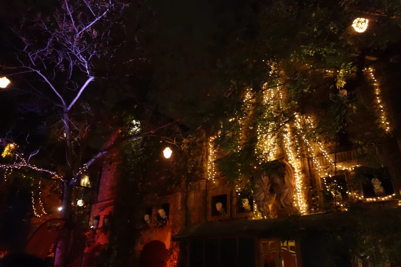 lighted lights adorn the front of an old house