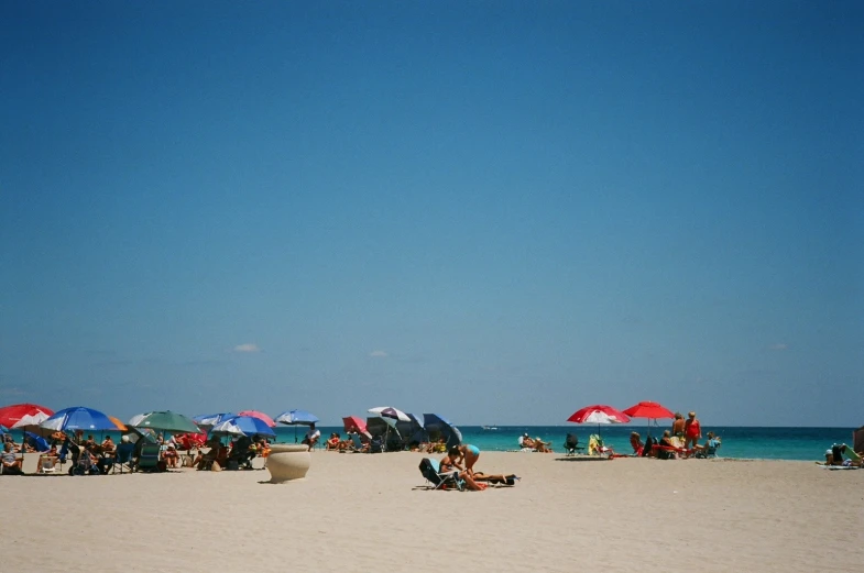 the beach is crowded with people on it