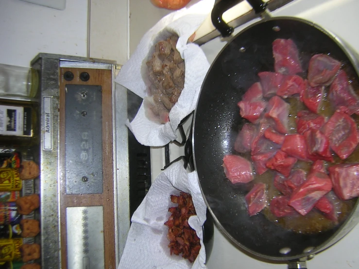  dog and meat sit inside of a frying pan