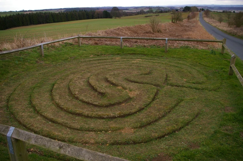 a big, spiral grass lawn on the side of the road