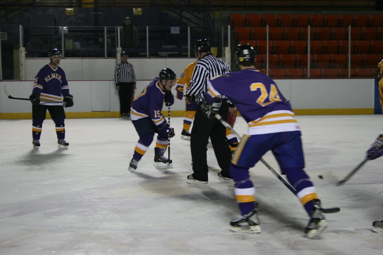 two teams of hockey players are playing ice hockey