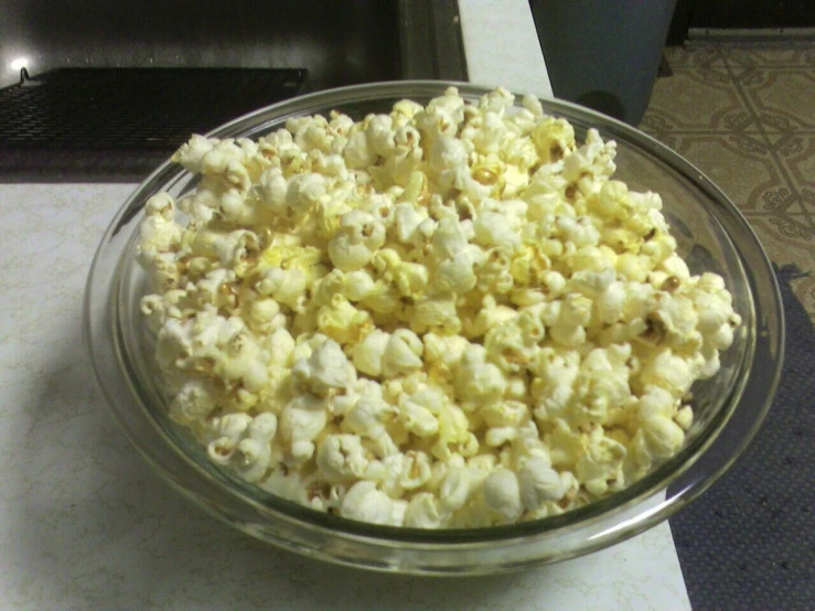 a bowl filled with some type of popcorn on top of a counter