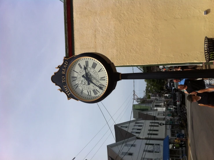 a clock is shown on the street corner