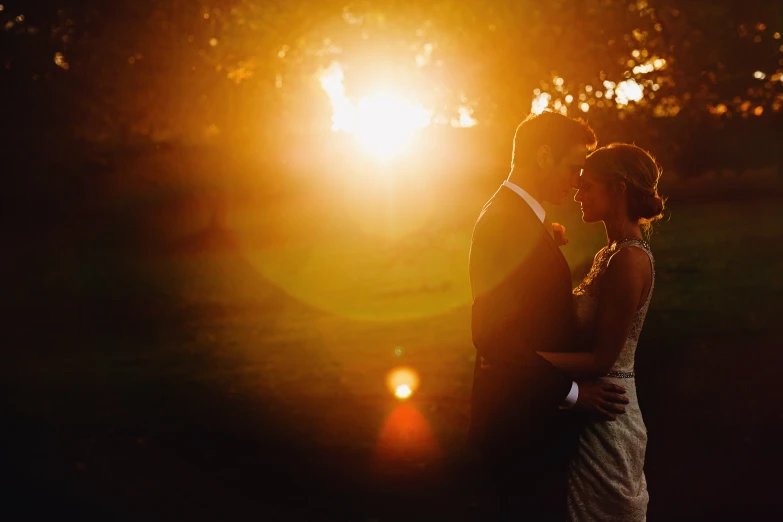 the silhouette of a bride and groom in front of a sunset
