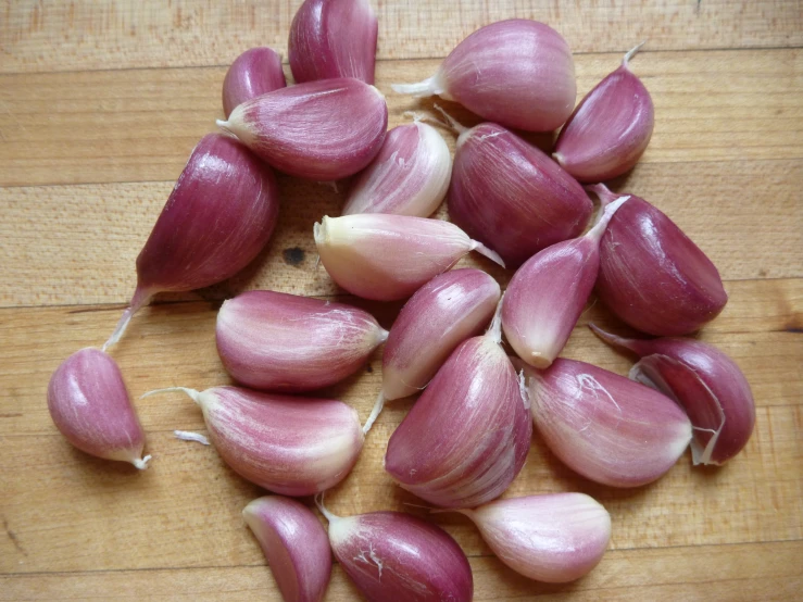 red onions are laid on a wooden surface