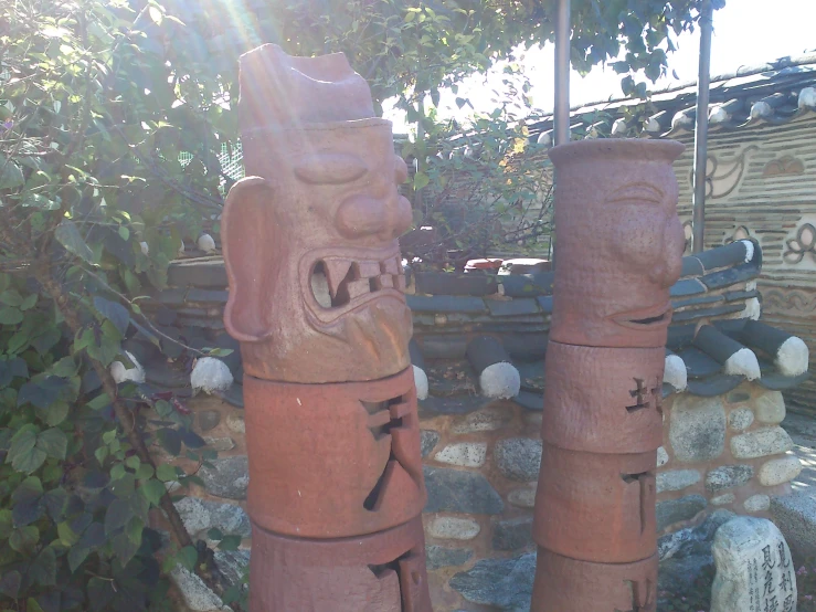 some very cute wooden statues by some trees