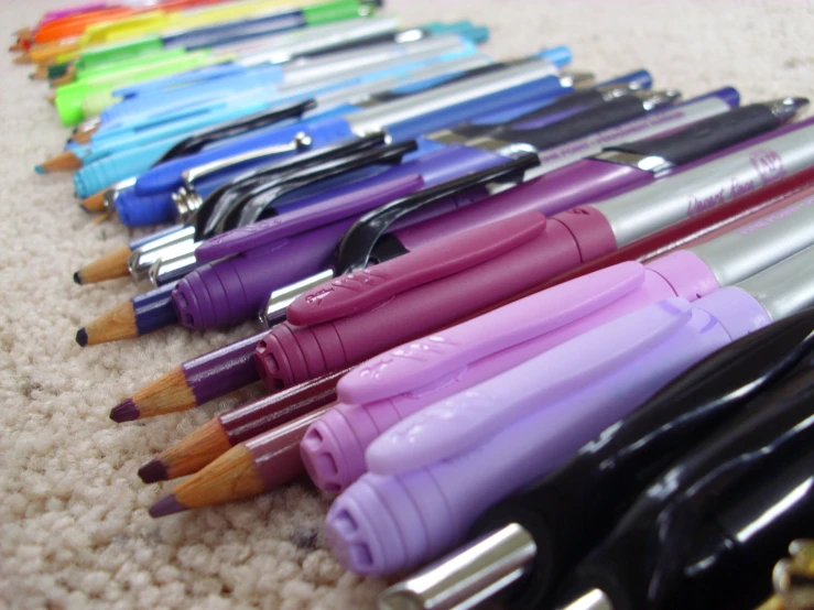 some colored pens lined up on the floor
