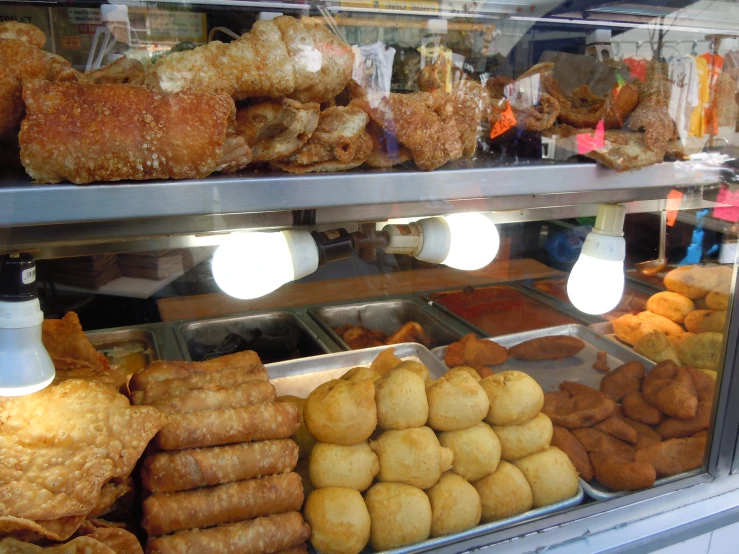 an assortment of baked goods in a bakery display case