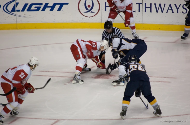 a group of people playing hockey on a rink