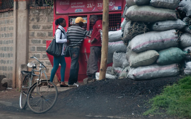 a group of people with large bags in front of a store