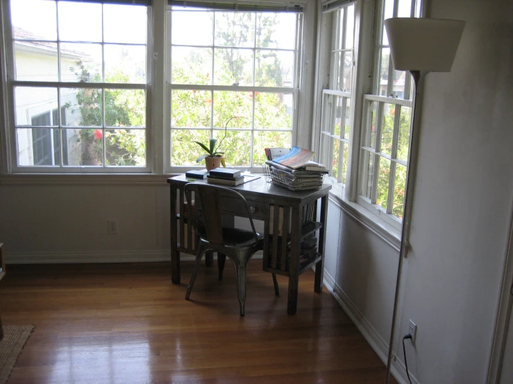 an office with wooden flooring and multiple windows