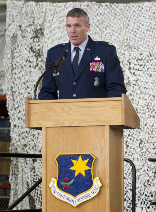 a person in a uniform is giving a speech