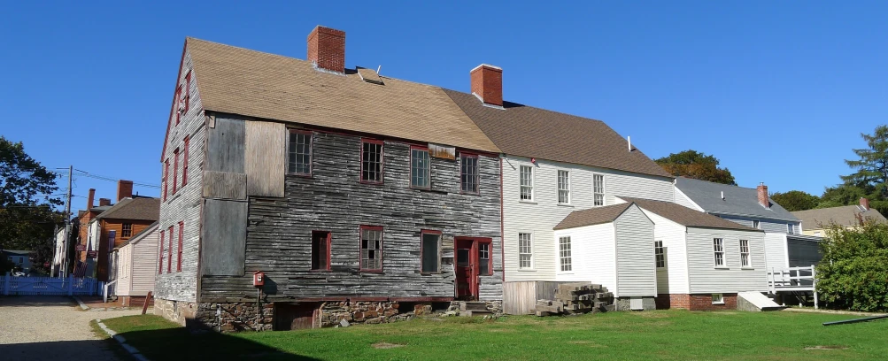 the large, old, two story house is white and red