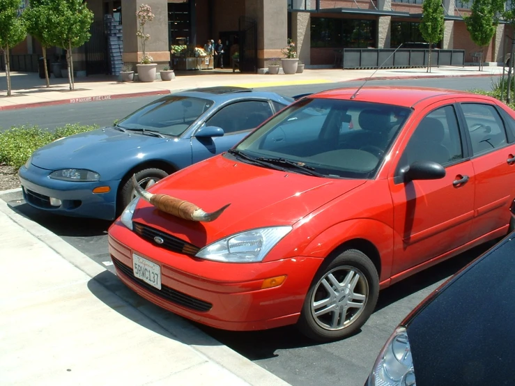 several cars parked in a parking lot on a street