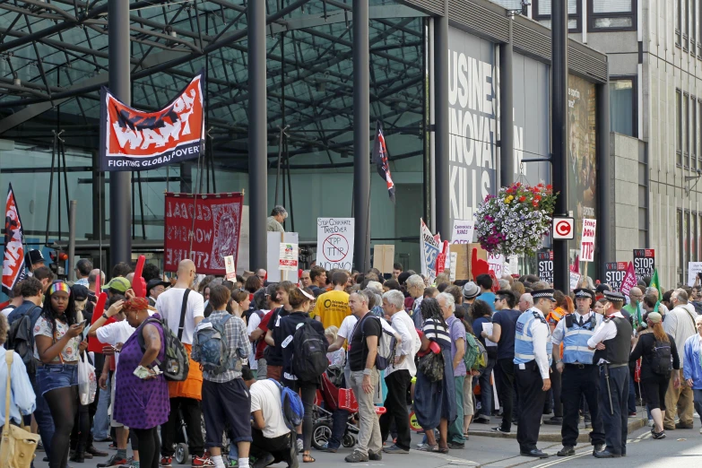 people are standing outside in protest outside of a building