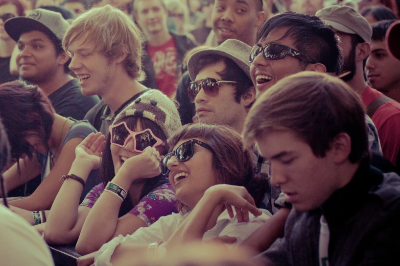 a large group of people sit together in a stadium